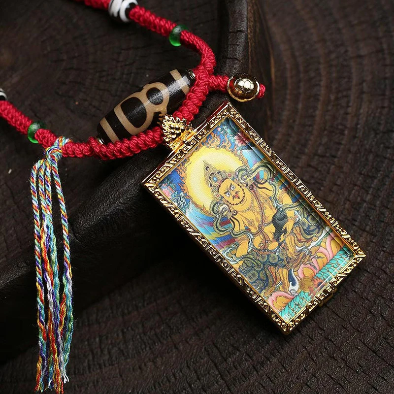 Square brass picture frame with gold-painted details, featuring Golden Wealth Deity Zaki Ram and Green Tara Thangka pendant,
