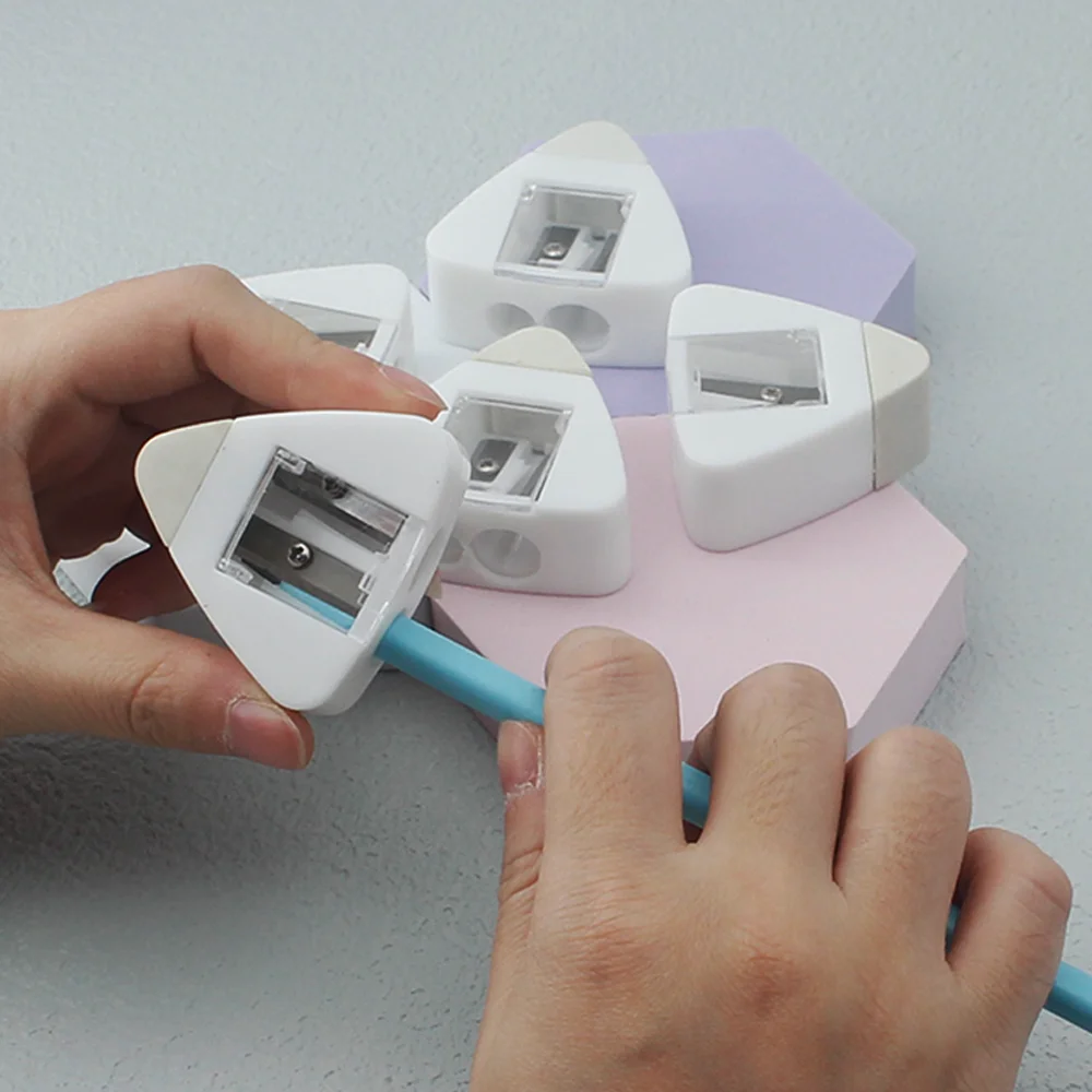 White triangular two-hole pencil sharpener with a flip cover, comes with an eraser. Durable and handy, the best helper for study