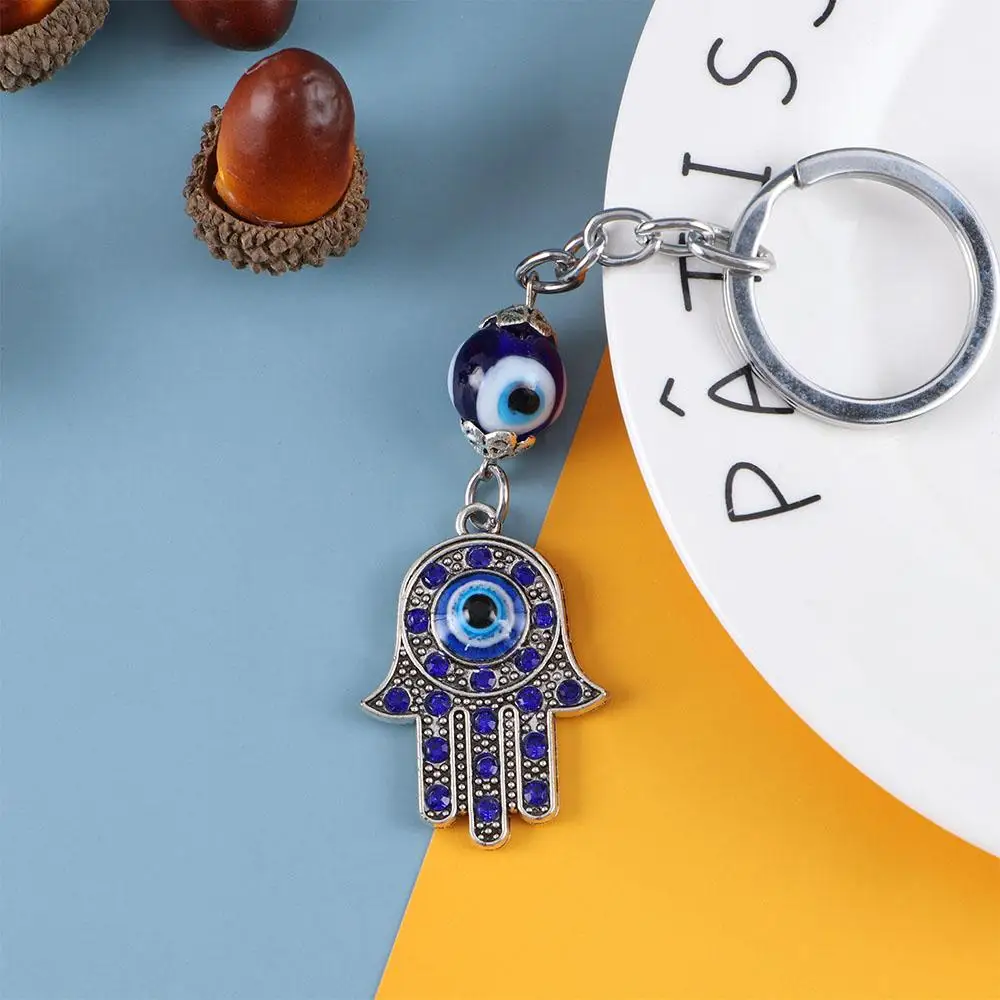 Colgante para hombre y mujer, amuleto azul, llavero para coche, llavero con la imagen de la Mano de Fátima, amuleto Hamsa, amuleto protector contra el mal de ojo.