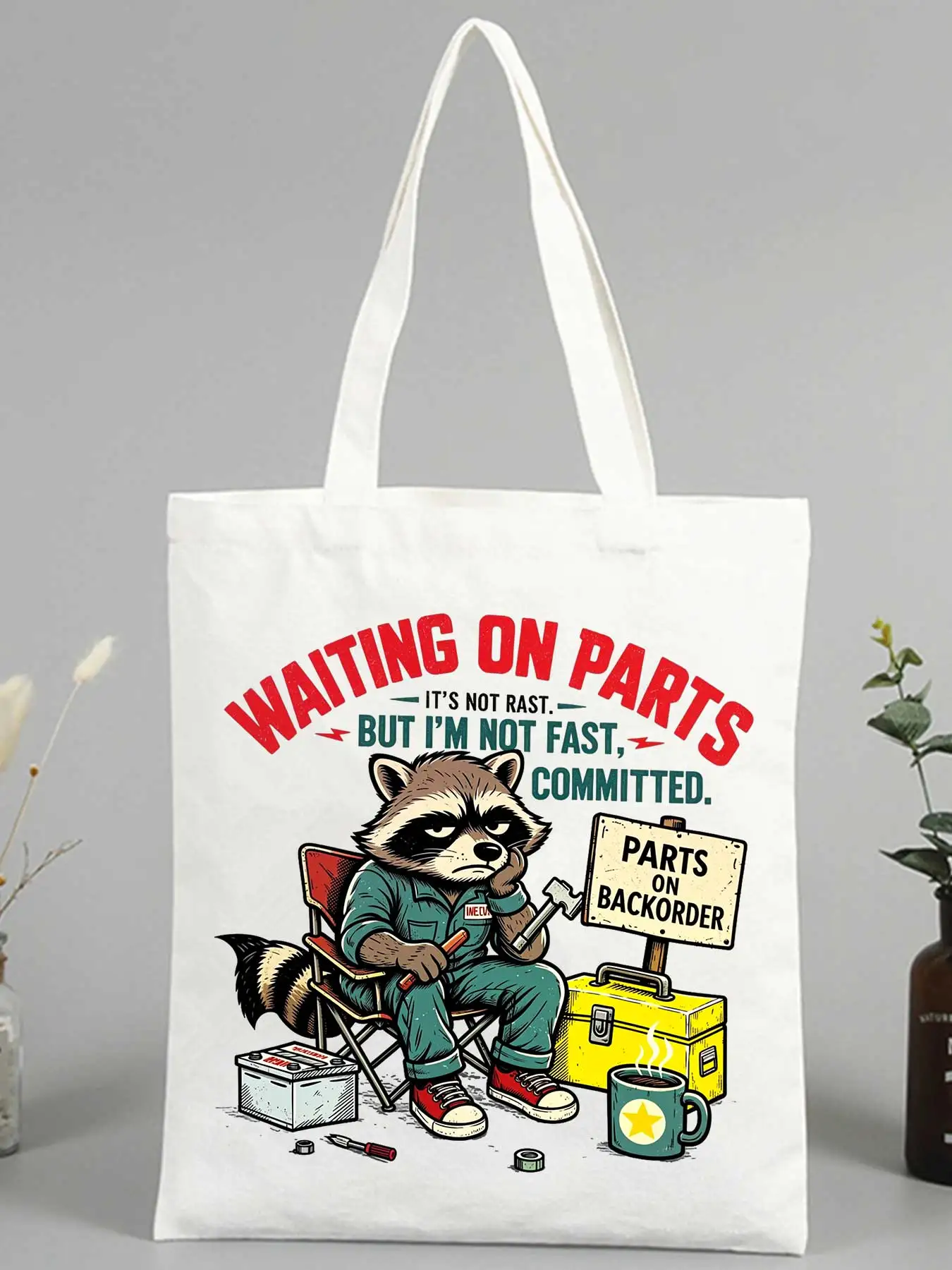 Women's canvas tote bag with raccoon mechanic graphic and slogan print, casual style for daily use and shopping
