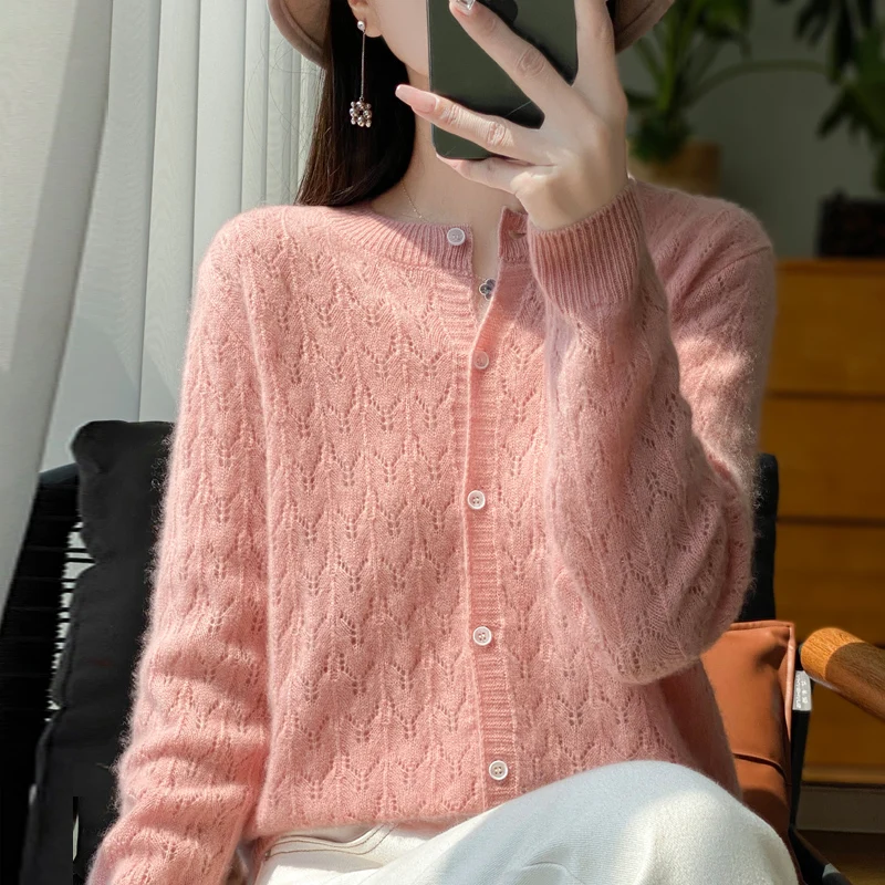 Autumn and winter new 100% pure wool cardigan female O-neck hollow crocheted solid color long sleeve sweater loose sweater coat.