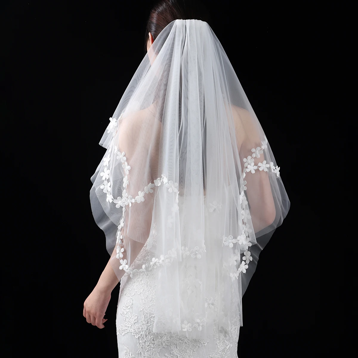 A white and elegant bride's veil, adorned with edging, suitable for women's wedding waist length veils