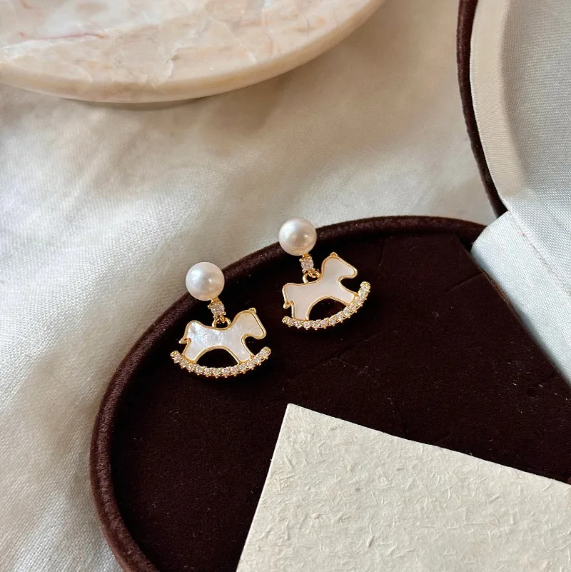 

Minar Creative White Fritillaria CZ Cubic Zircon Imitation Pearl Cartoon Horse Dangle Earrings for Women Real Gold Plated Copper