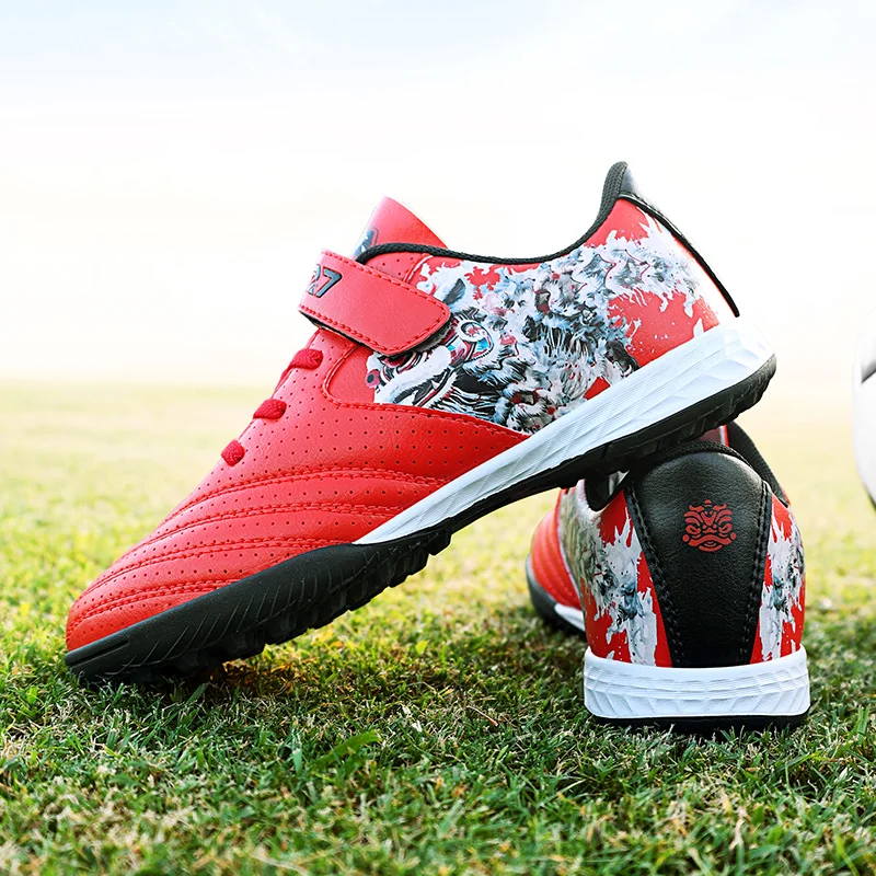 

A pair of children's football shoes with anti-slip rubber soles, breathable mesh upper, and a no-buckle designXN-749