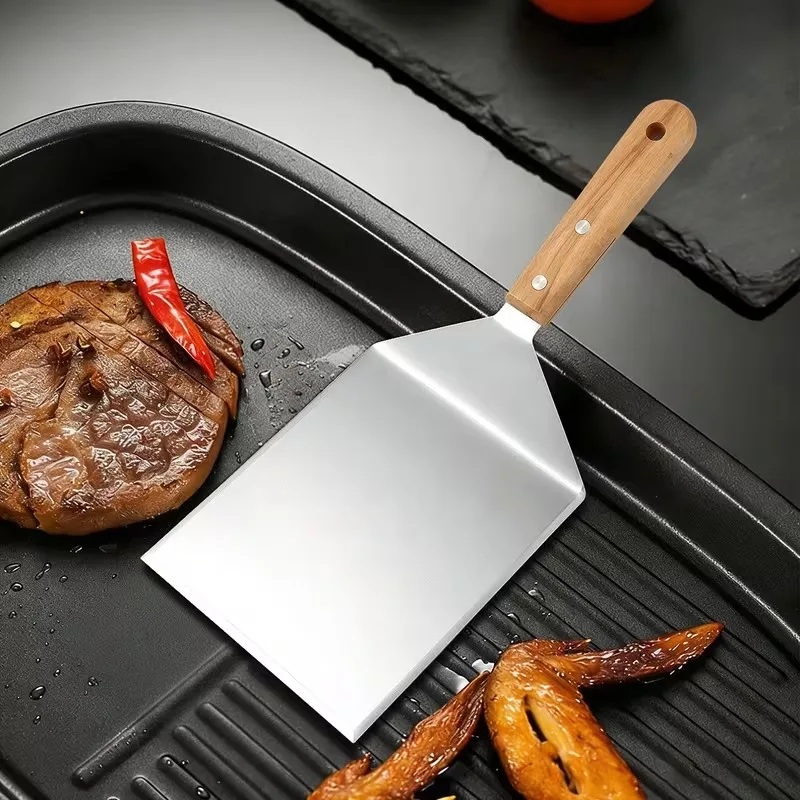 Stainless steel multi-functional cooking spatula – ideal for grilling and searing steaks, suitable for home and outdoor use.