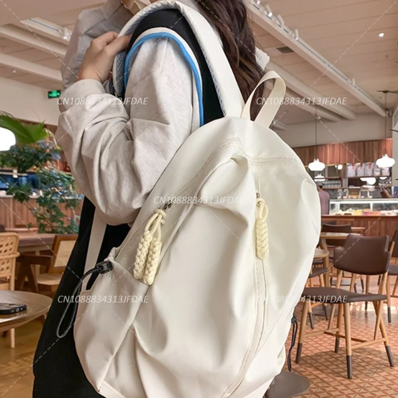 กระเป๋านักเรียนความจุขนาดใหญ่สําหรับผู้ชายและผู้หญิงกระเป๋าเป้สะพายหลังกีฬาลําลองกระเป๋าเป้สะพายหลังเดินทางสีทึบเรียบง่าย