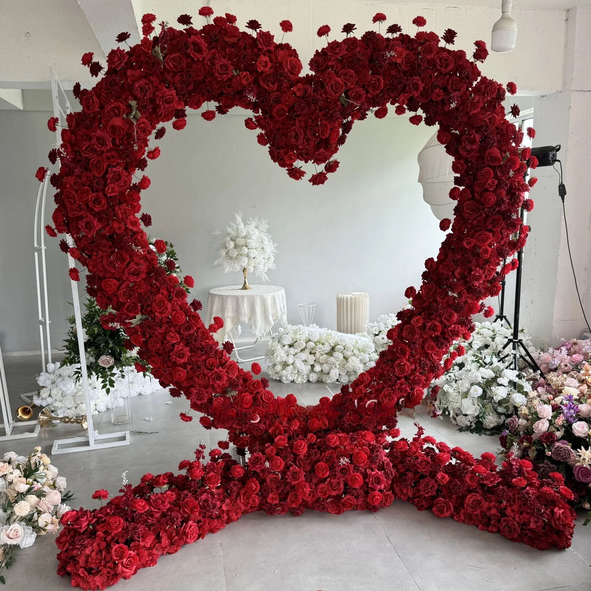 

Giant romantic heart shaped arch flower background red and white roses for wedding decoration with flowers