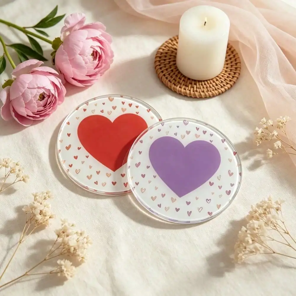Round acrylic coaster featuring a heart print: a white background covered in tiny hearts, with a large heart in the center.