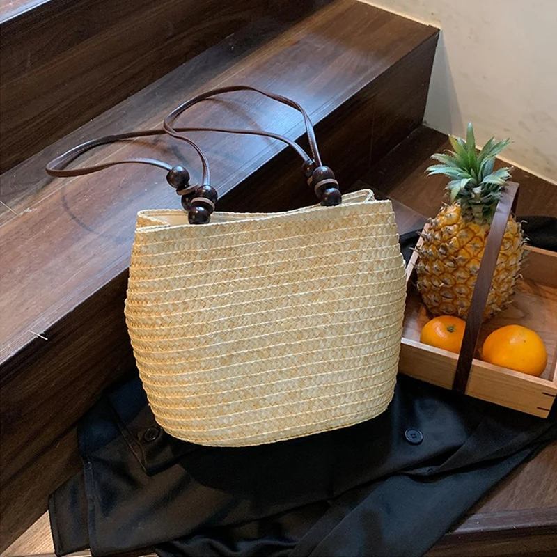 Niche Forest Bucket Bag Holzperlen Magnetschnalle Umhängetasche Retro High-End Stroh gewebte Shopper-Einkaufstasche