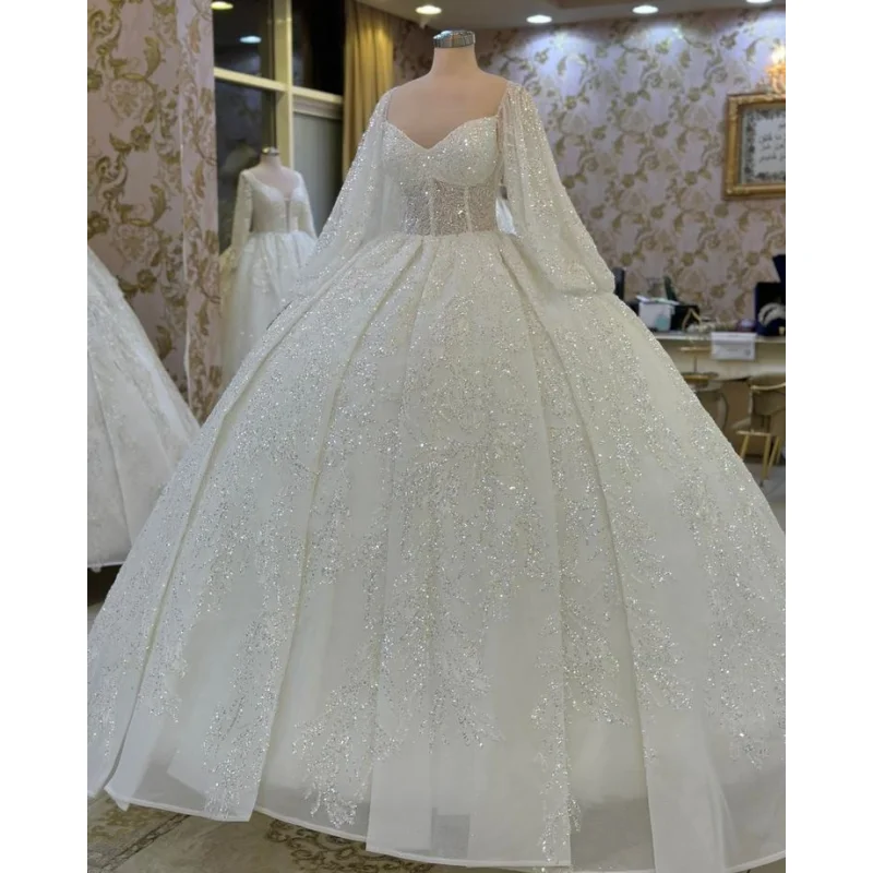 

Элегантное свадебное платье на заказ с блестящим материалом, вырезом «сердечко», длинными рукавами и пышной юбкой (Vestido De Novia)