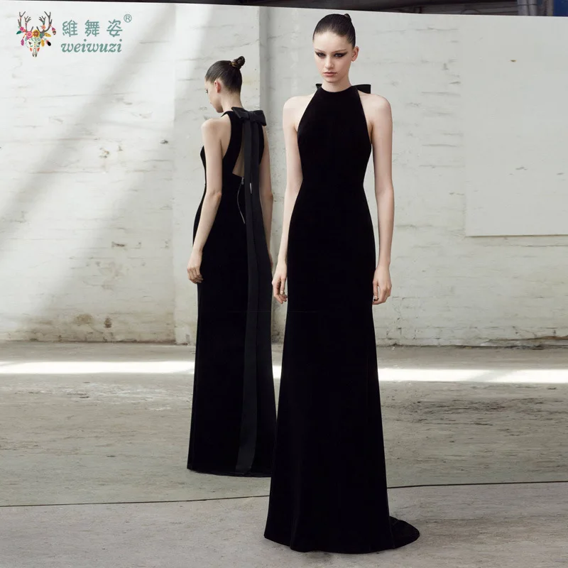 فستان سهرة بتصميم عصري برقبة معلقة بدون أكمام ذهبي مخملي وطول يصل إلى الأرض مع فيونكة بدون ظهر للمناسبات الرسمية