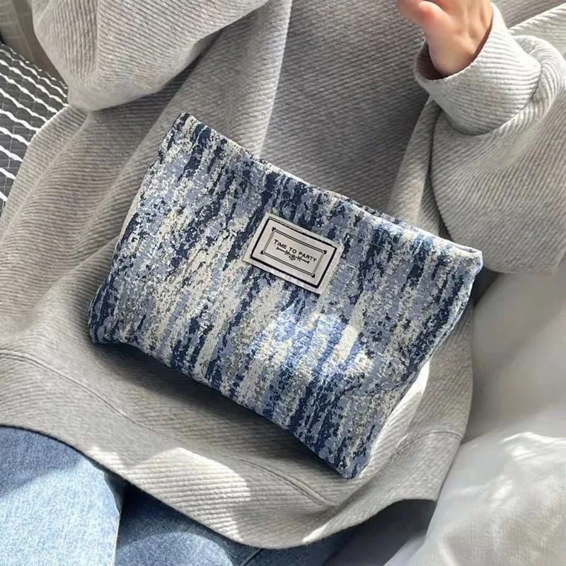 Borsa per il trucco design di nicchia originale strisce di temperamento in bianco e nero arte retrò elegante mano in mano con borsa per il trucco