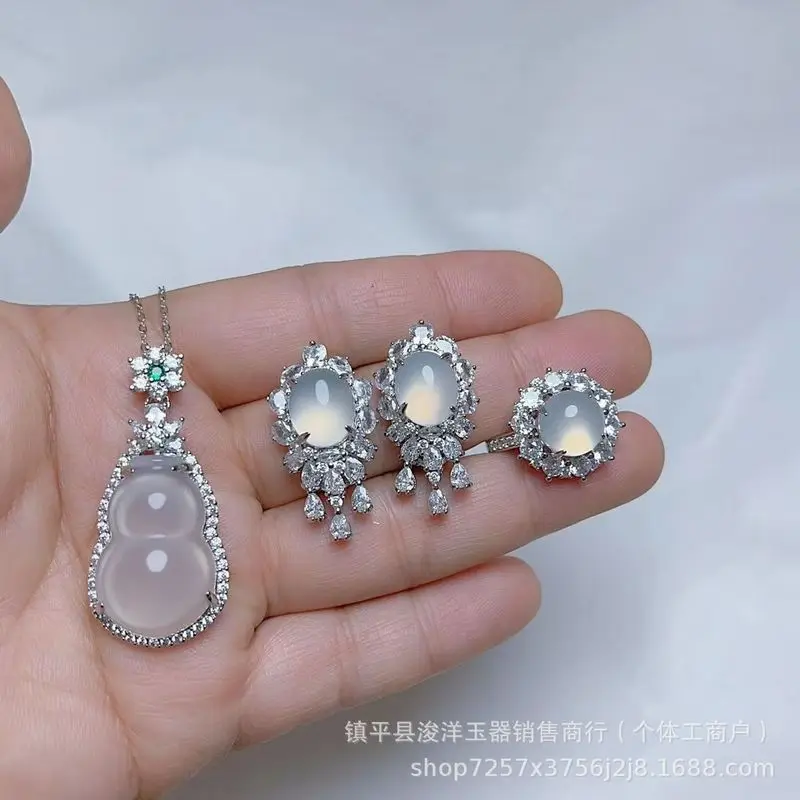 Silver-plated set with natural high-quality white chalcedony in a pigeon egg shape, including a necklace, pendant, earrings, and