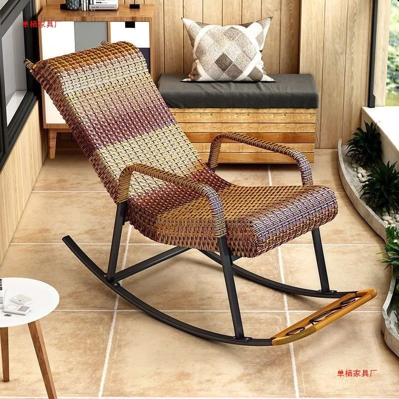 Rattan rocking chair on a balcony with plants