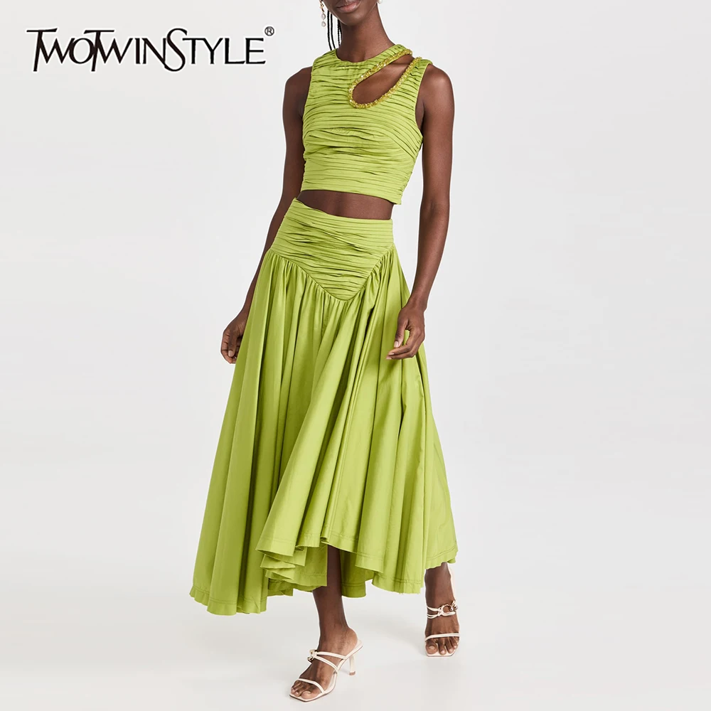 

TWOTWINSTYLE Solid Spliced Folds Two Piece Set For Women O Neck Sleeveless Hollow Out Vest High Waist Skirt Set Female Clothes