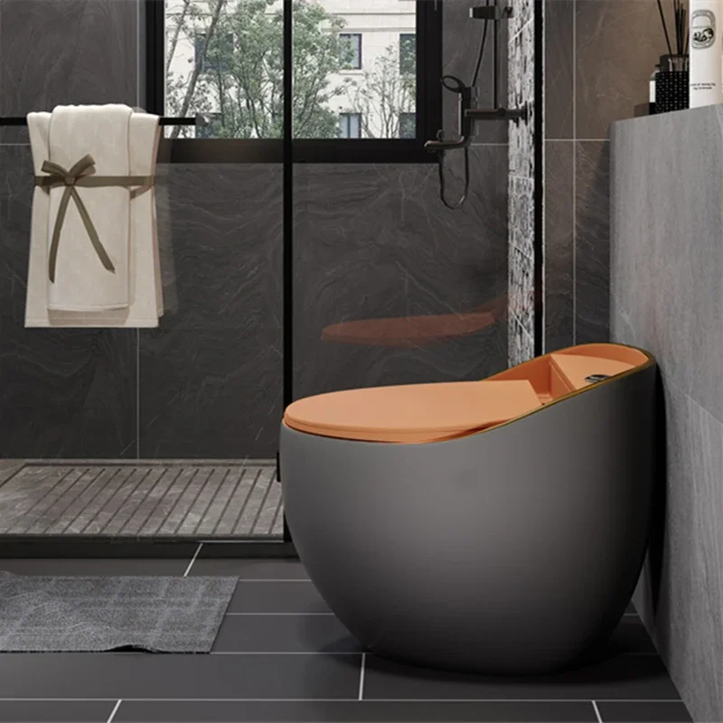 xx-Hot Sale Egg Shaped Floor Mounted One Piece Black Ceramic Toilet Bowl With Orange Seat Cover