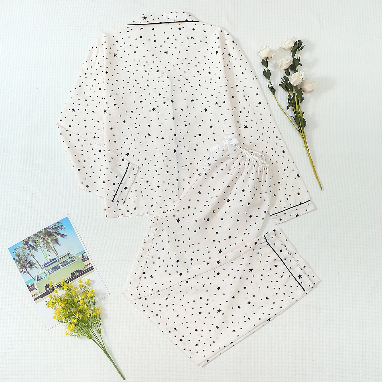 Two-piece comfortable white top with large and small star prints, turn-down collar, button closure, and bow-tie pants, women's pajama and loungewear set suitable for home use