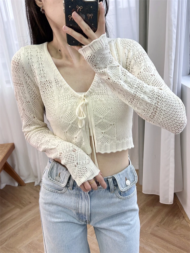 Short hollow knit sweater in beige French style with a lace up front and a beach casual style, new for summer 2024