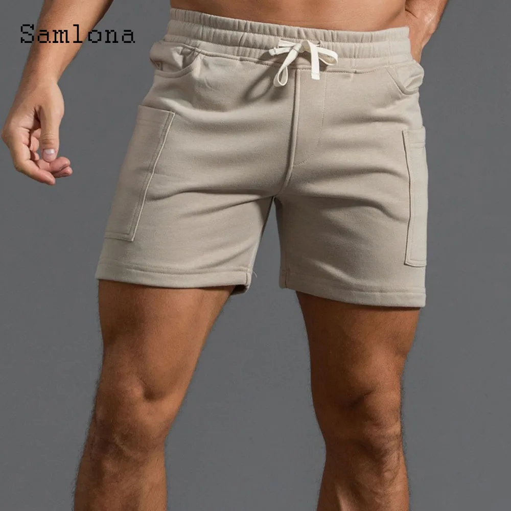 2025 ฤดูร้อนใหม่กางเกงขาสั้นสบายๆผู้ชายเซ็กซี่เอวยางยืดกางเกงขาสั้นชายขาตั้งกระเป๋าฟิตเนสชายหาดสั้นกางเกงสีเทาสีขาว