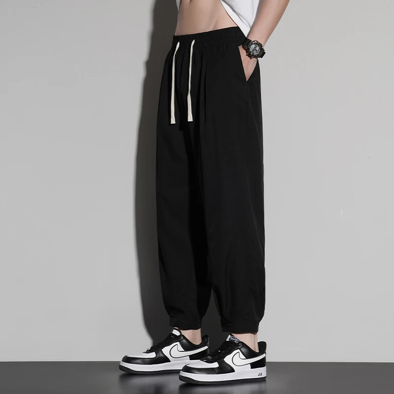 New trend summer men's solid color pocket drawstring elastic casual ice silk leggings loose wide leg cropped sports pants