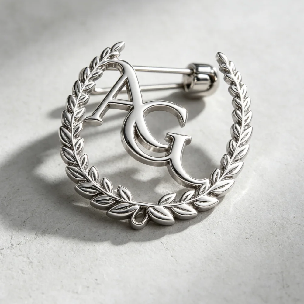 Custom gold laurel wreath monogram AG brooch, polished metal personalized lapel pin for suit decoration and upscale gifts.