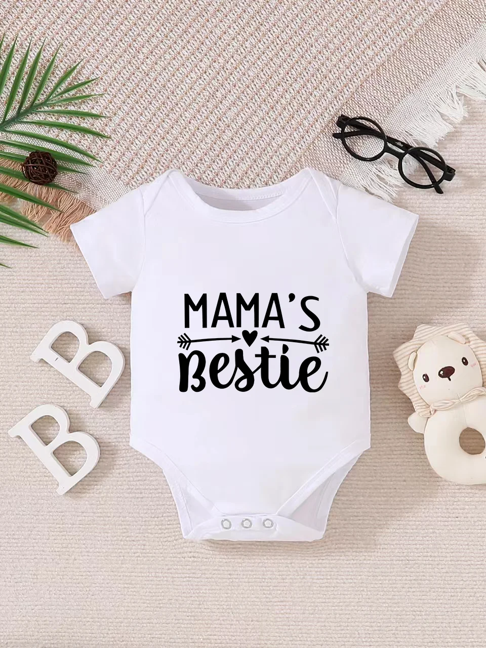 Playful letter-printed baby short-sleeve triangle bodysuit. Button closure for easy dressing, machine washable