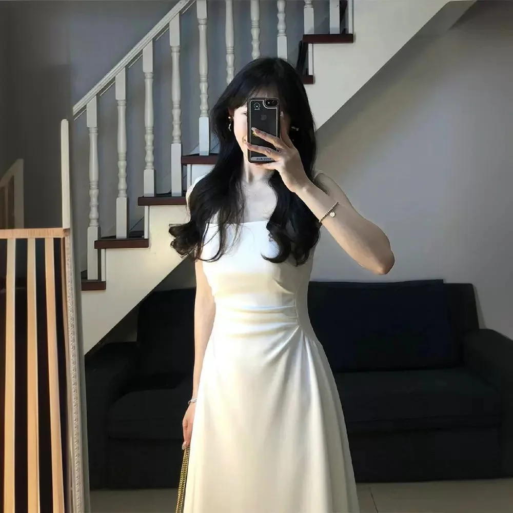 

Белое платье-бретелька для летних женщин, новинка 2025, стиль, трапециевидной формы, длинная юбка с французским темпераментом и талией, нишевый дизайн