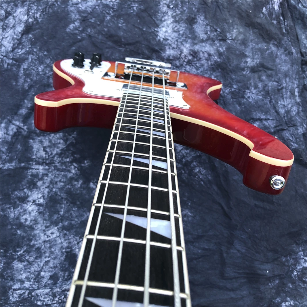 This is a professional 4-string bass electric guitar with a sunset color changing bright face. It has a beautiful tone