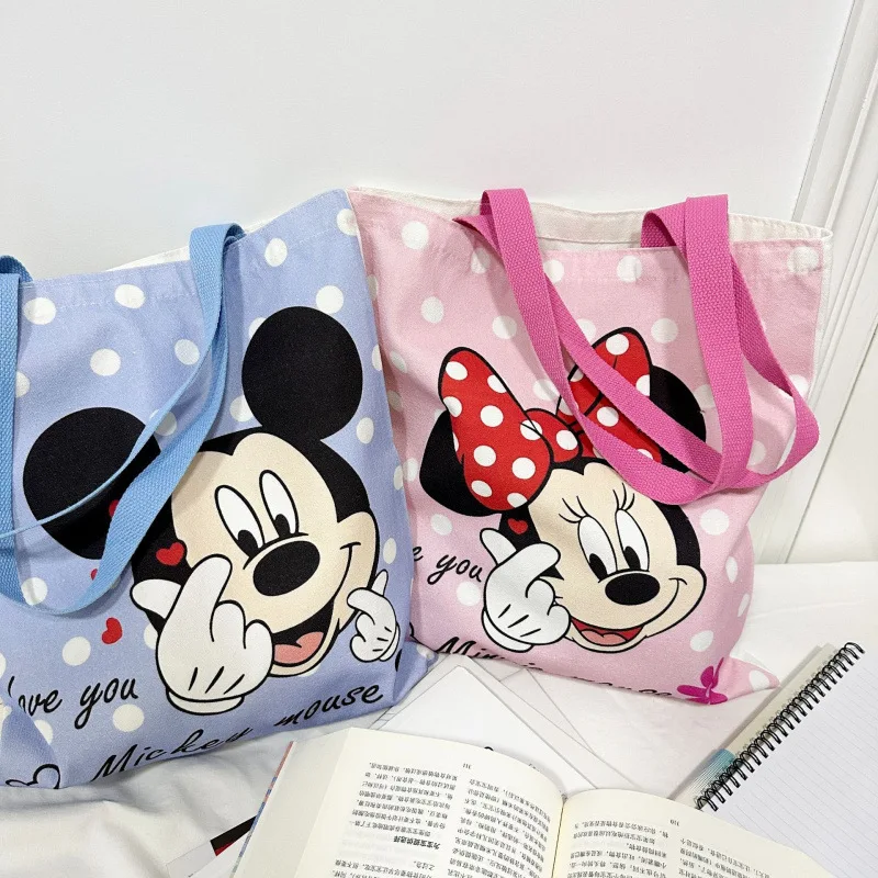 ใหม่ Kawaii Mickey Mouse ผ้าใบกระเป๋าอะนิเมะ Minnie Mouse อุปกรณ์เสริมกระเป๋าสะพายนักเรียนกระเป๋าเป้สะพายหลังการ์ตูนมือถือช้อปปิ้งกระเป๋า