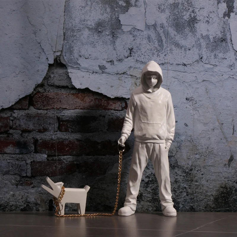 Banksy a trendy man playing with dogs, white fashion toys, art sculptures and ornaments