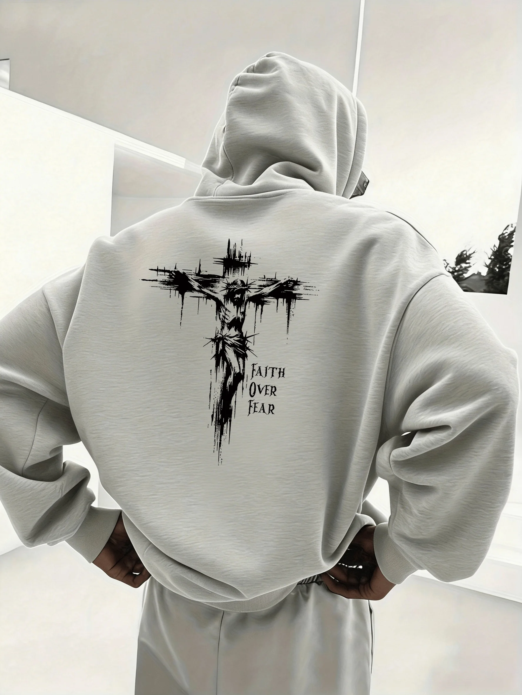 Cross-shaped dark-haired men's hooded sweatshirt with distressed cross pattern. A fashionable and comfortable style.