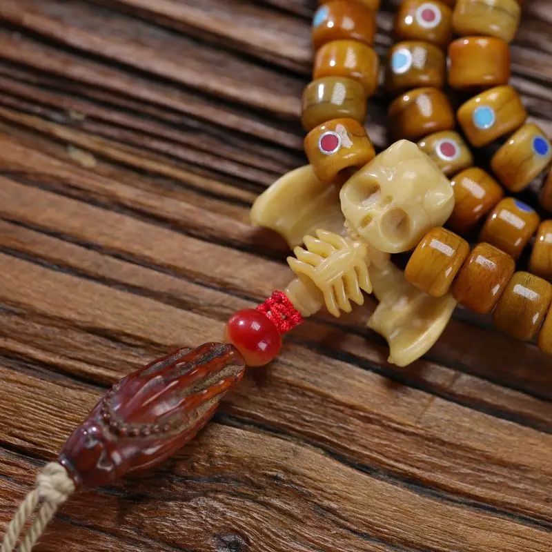 Tibetan bone bead rosary with 108 featuring multi-treasure-style turquoise dzi beads