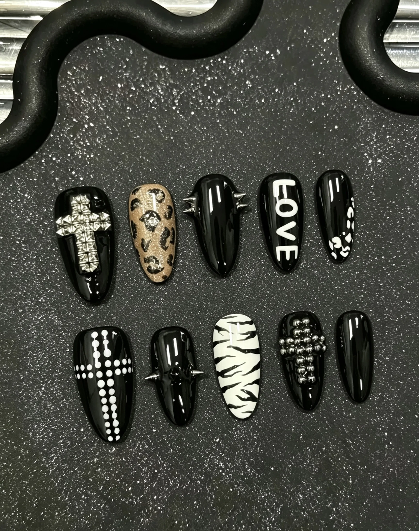 10-Piece Set of Wild Punk Style Press-On Nails, Long Pointed Nails, Y2K Punk Hot Girl Style, Mainly Black Base Color, with Leopard and Zebra Prints, Featuring 3D Rivet Spikes, Cross Rhinestones, and Love Letters, for a Sweet and Cool Wild Look
