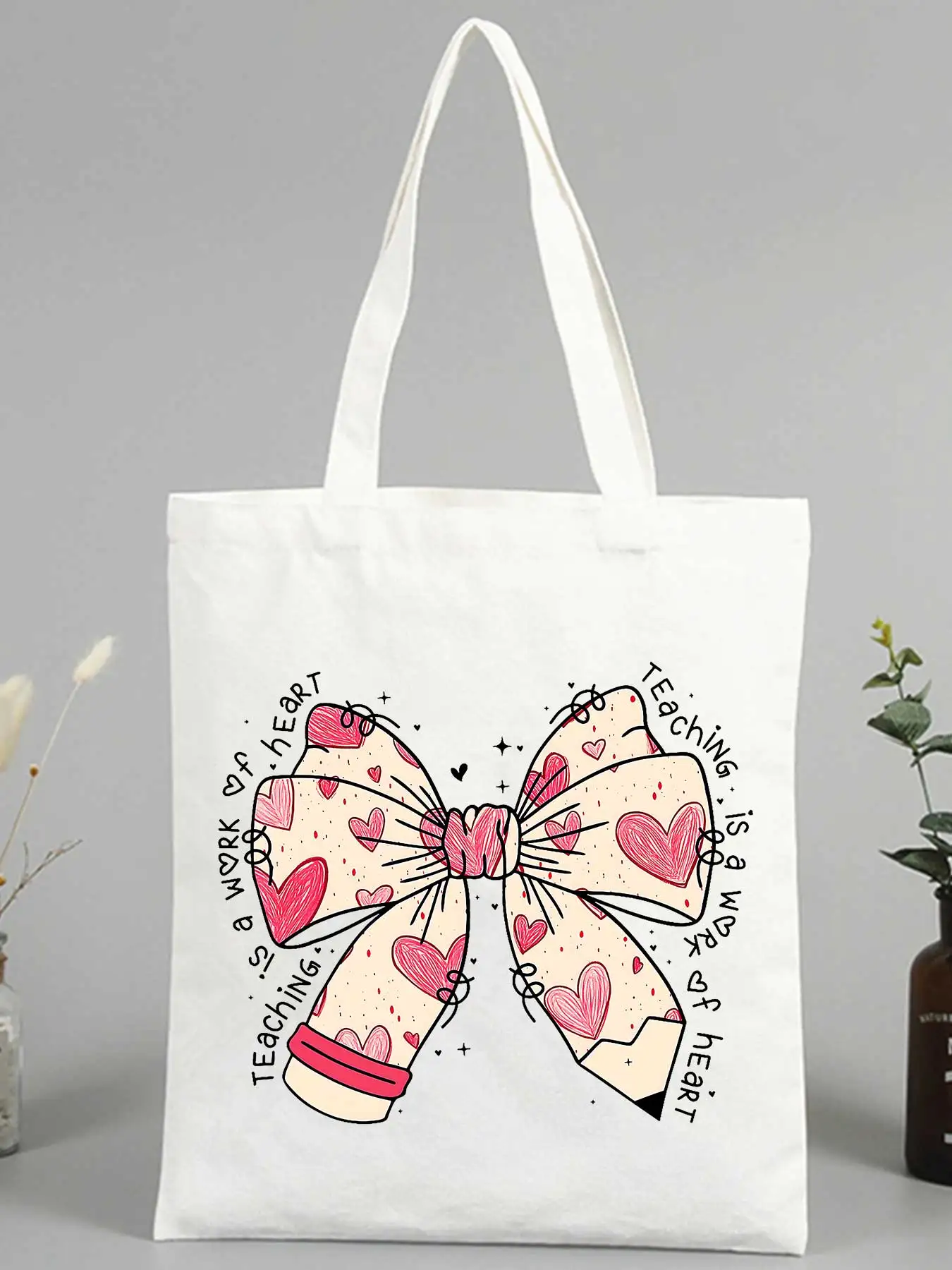 Women's canvas tote bag with heart bow and letter print, ideal for casual daily use and shopping