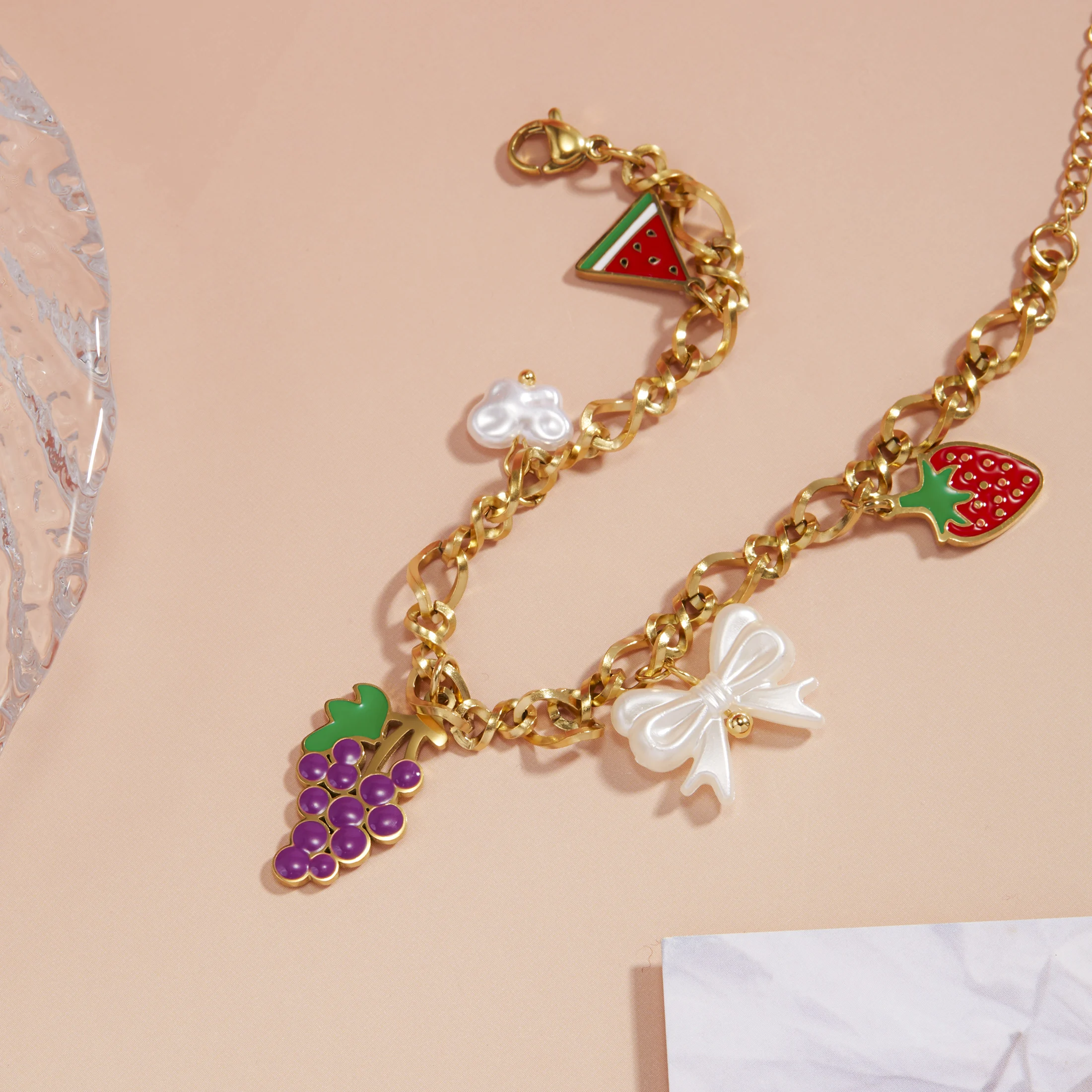 

Golden Tone Stainless Steel Fruit and Bow Charm Bracelet with Enamel and Imitation Pearls for Women