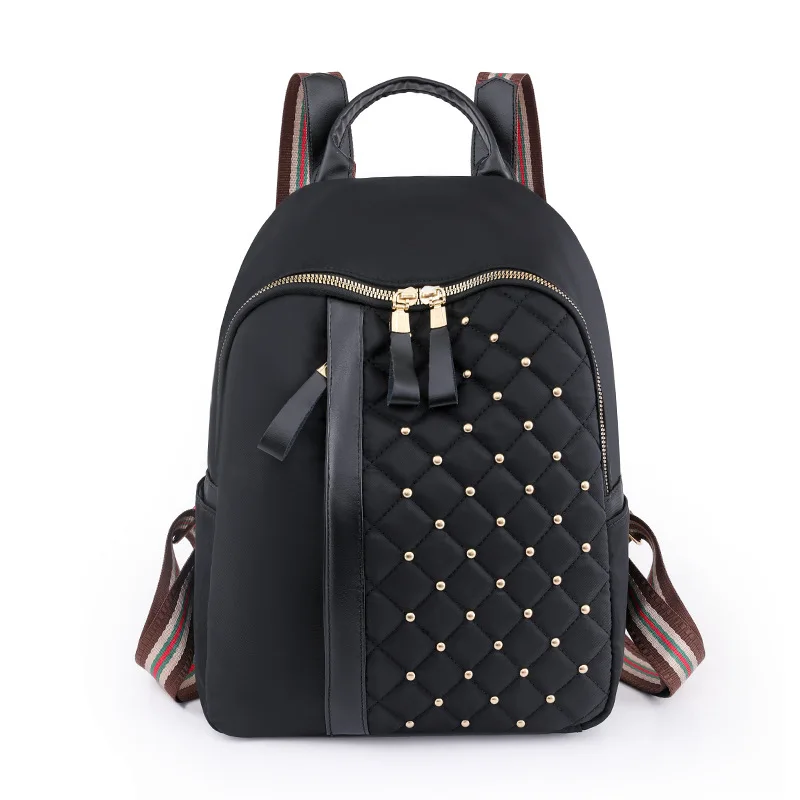 Europe and The United States New Schoolbag New Casual Oxford Cloth Backpack Simple Trend Light Rivet Embroidered Backpack.