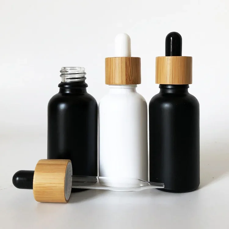 

Refillable frosted white black glass dropper bottle liquor with bamboo cap serum glass essential oil bottle glass dropper bottle