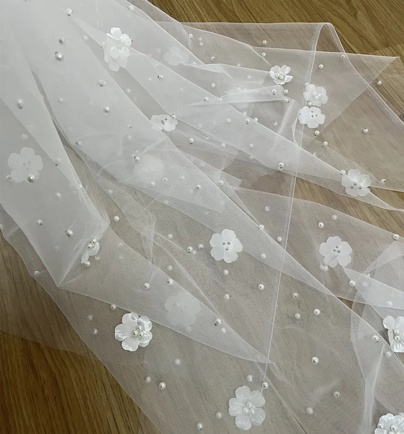 

Transparent mesh embroidered fabric with pearl flowers is a perfect decoration for wedding dresses and scene arrangements