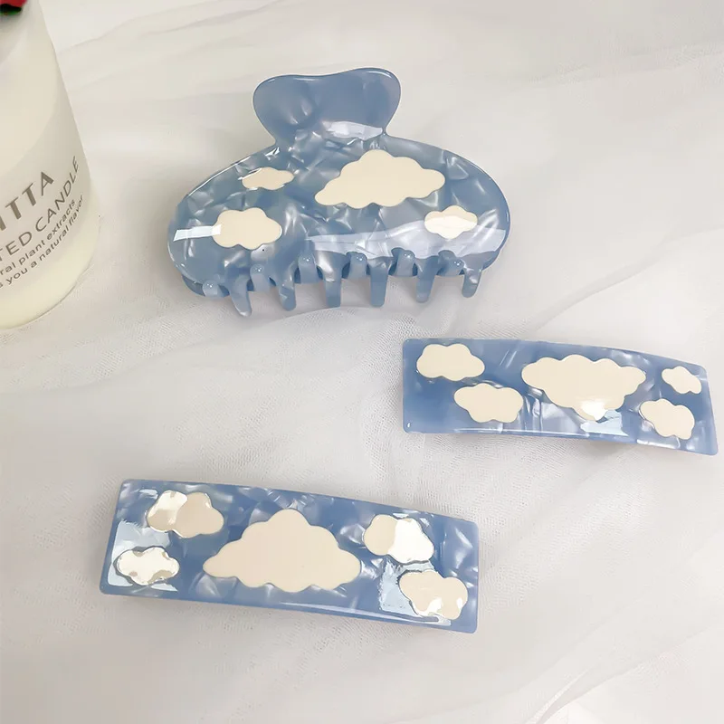 

Sky blue acrylic hair clip with white cloud pattern, a vintage romantic hair accessory suitable as a gift for women