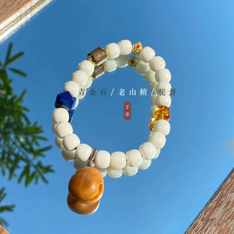 

Браслет-колокольчик из белого сандалового дерева Bone With Lapis