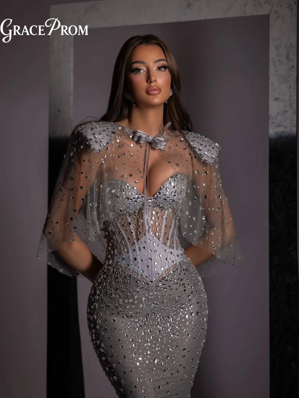 

Elegant Silver Crystal Beaded Mermaid Evening Gown 2026 Radiant Sheer Cape Corset Top Party Dress For Wedding Guests فساتين سهرة