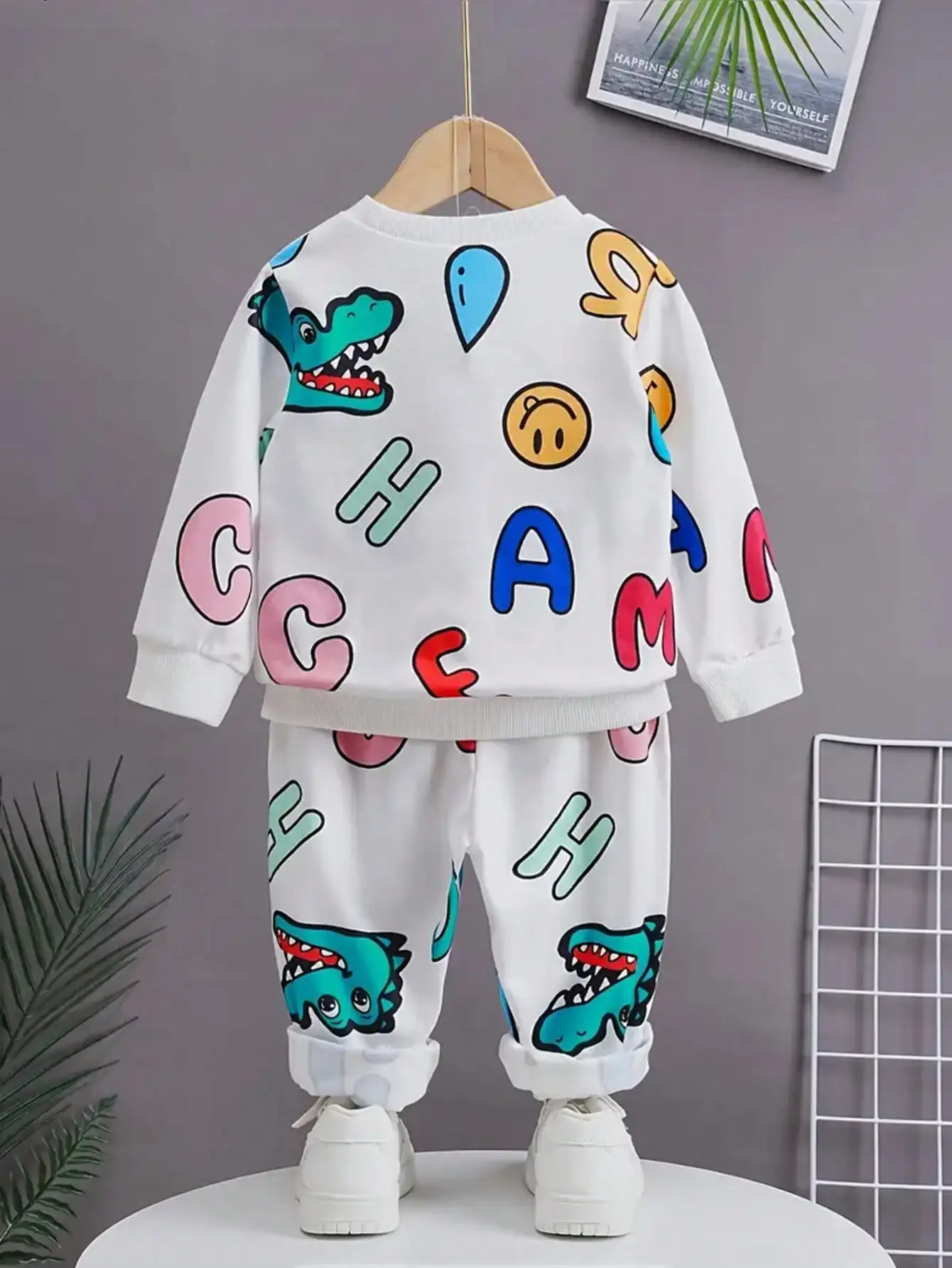 Ribbed cuffs and collar with fun letter patterns, cheerful smiling faces, and dinosaur patterns printed on them