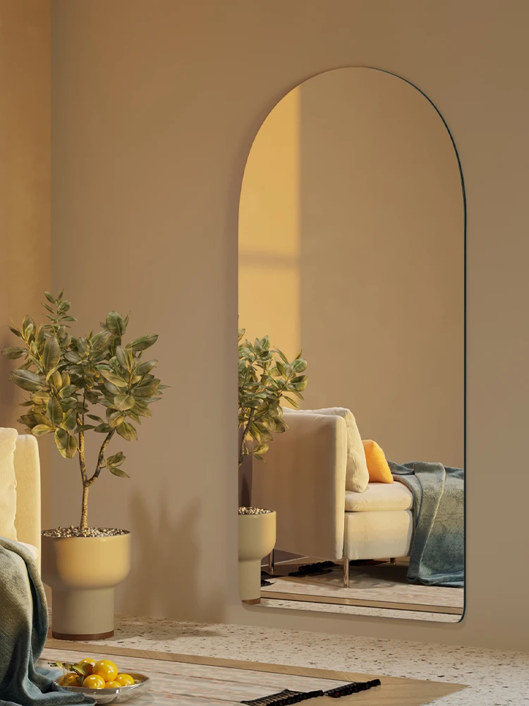 The arched entrance has a full body mirror wall that is hung on the wall, and the dressing mirror is attached to the wall.