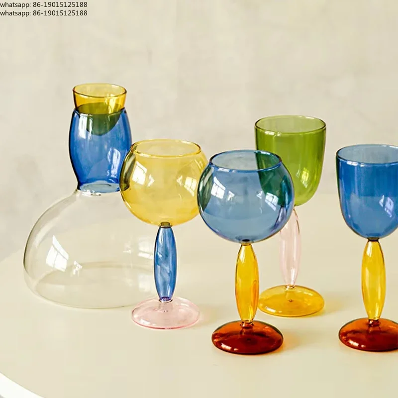 Handmade colored glass cups, creative champagne glasses, contrasting Bordeaux Burgundy red wine glasses, decanter