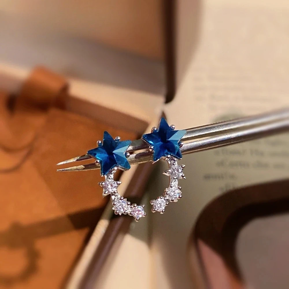 Exquisite 925 sterling silver single-row earrings for women featuring a bright blue crystal star-shaped decoration.