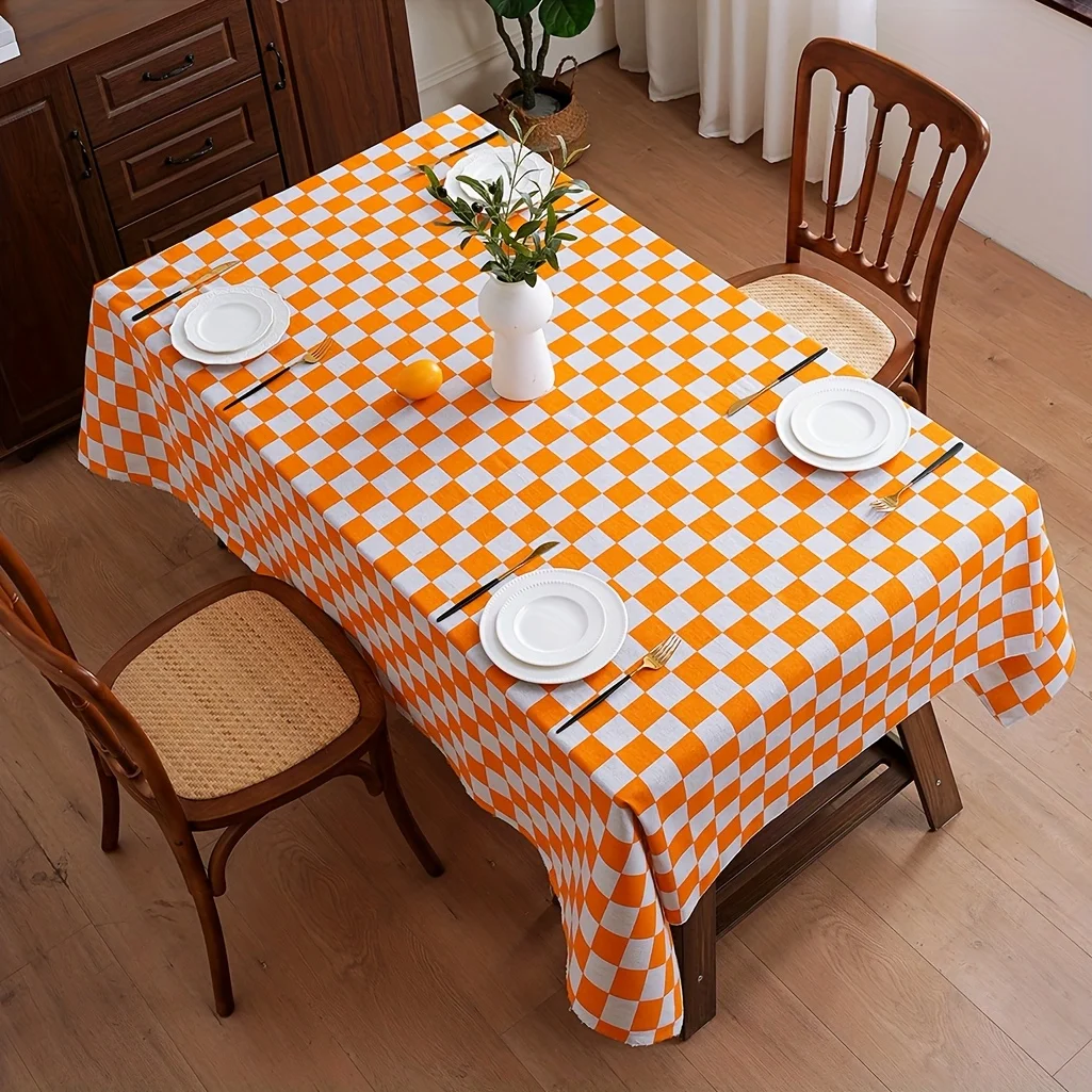 A tablecloth in orange and grey checks, decorated with lace trimmings