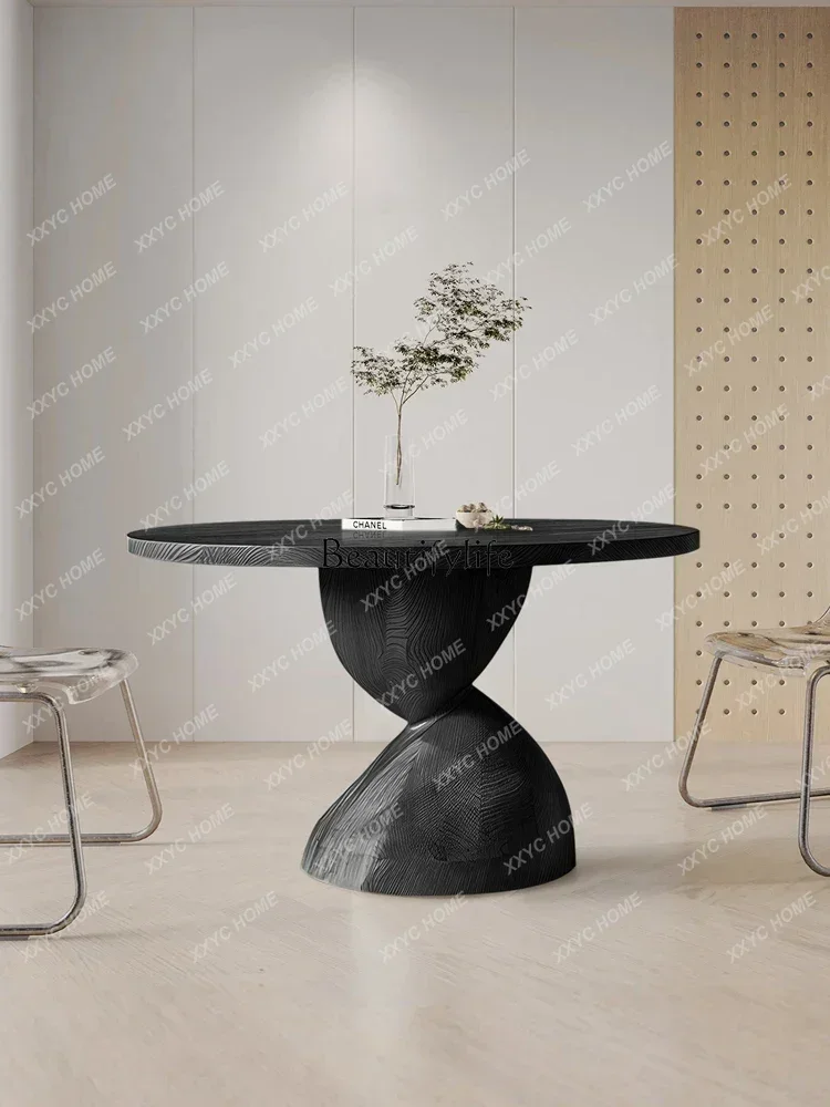 A  round solid wood dining table special-shaped high-grade ash wood household dining table
