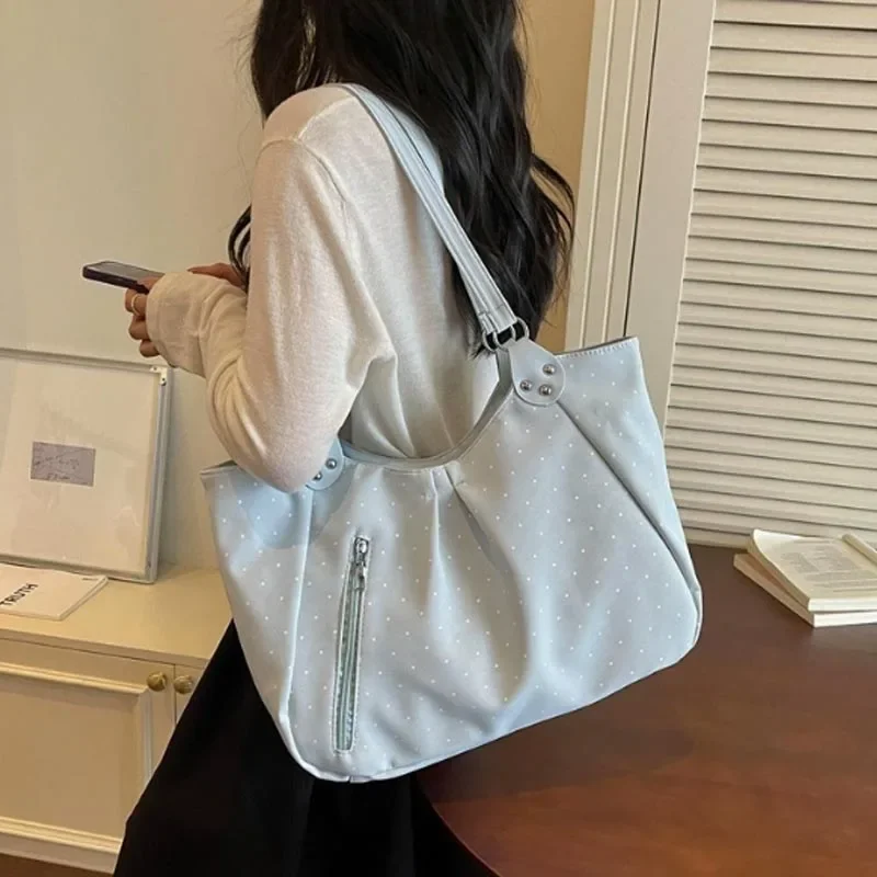 Light blue polka dot canvas tote bag large capacity with silver zipper and metal hardware.