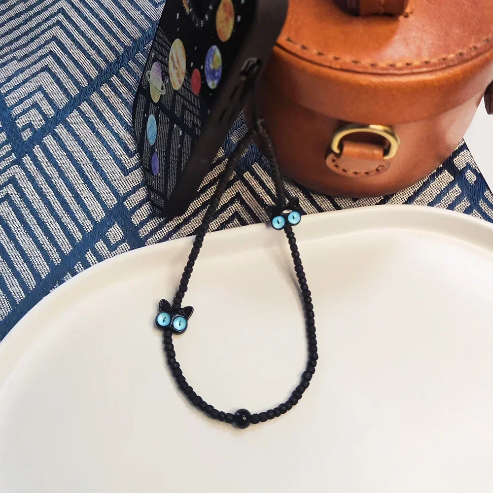 Bracciale da polso con cinturino per telefono gatto nero cartone animato Gatti occhio blu Catene per cellulare con perline Accessori per cordino con ciondolo per telefono anti-smarrimento