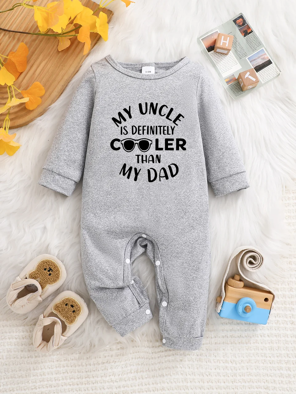 A baby long-sleeved onesie with interesting letter prints. It features a buttoned design for easy putting on and taking off